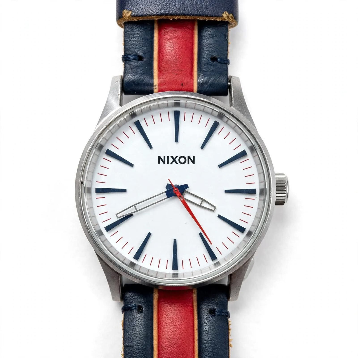 NIXON The Sentry 38 – White Dial – Navy Blue Genuine Leather Strap with Bold Red Stripe + Beige Piping – Silver Steel Case – 100M Water Resistant – Men’s Casual Leather Watch