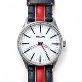 NIXON The Sentry 38 – White Dial – Navy Blue Genuine Leather Strap with Bold Red Stripe + Beige Piping – Silver Steel Case – 100M Water Resistant – Men’s Casual Leather Watch